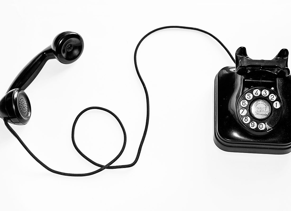 Vintage telephone with the handset off the hook